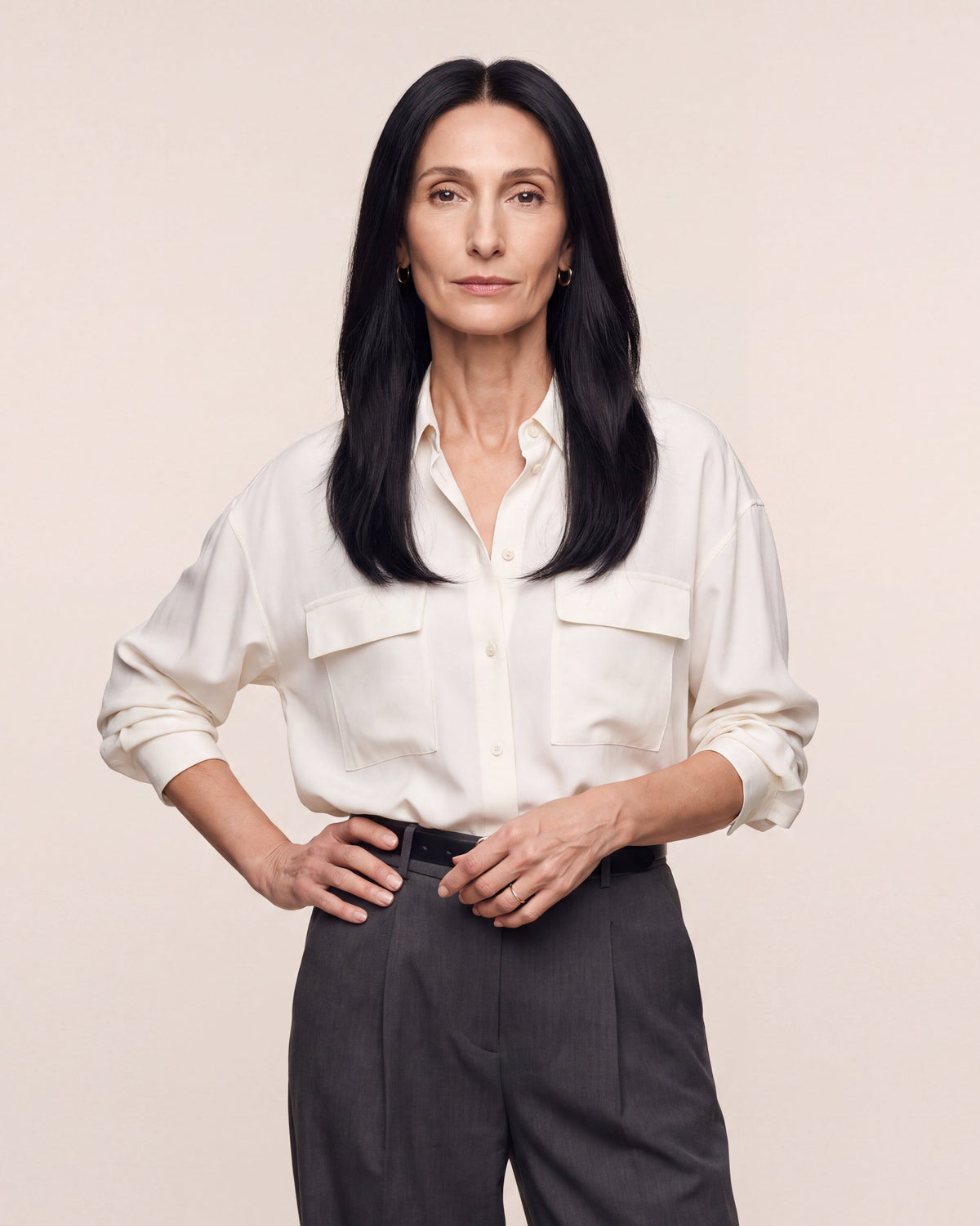 Hairline topper worn under a white blouse; dark straight hair with natural-looking part