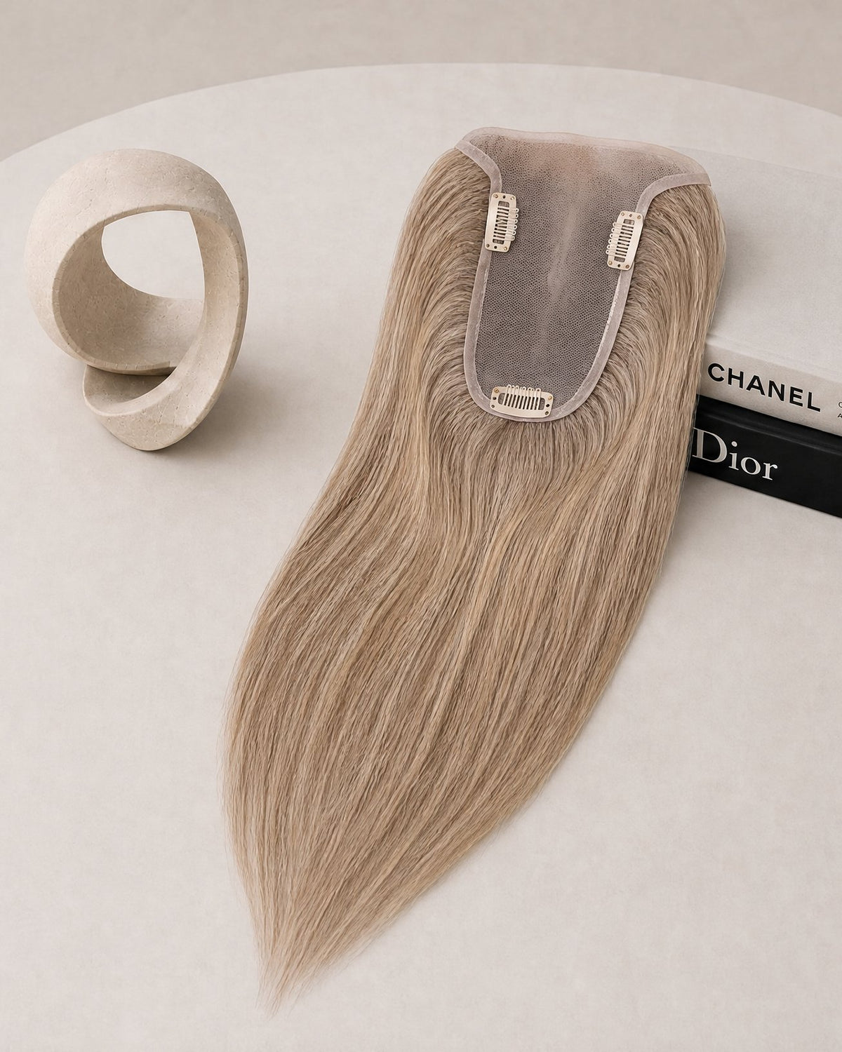 Hairline topper in light blonde with sheer lace base and two securing clips at top
