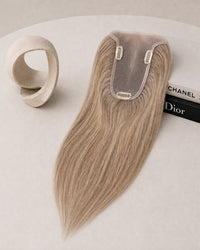 Hairline topper in light blonde with sheer lace base and two securing clips at top