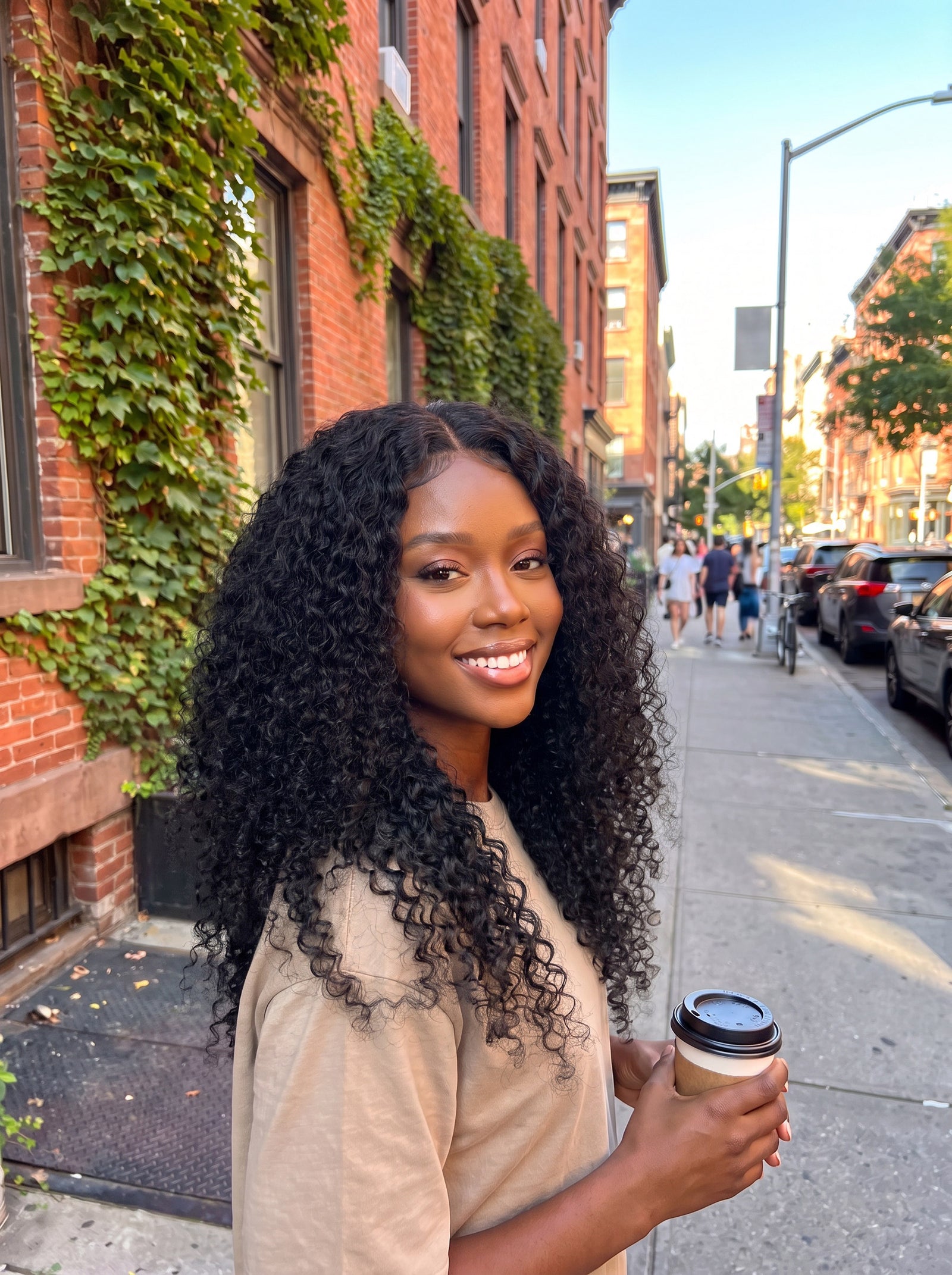 Curly U-part wig on a model with long black curly hair in loose ringlets
