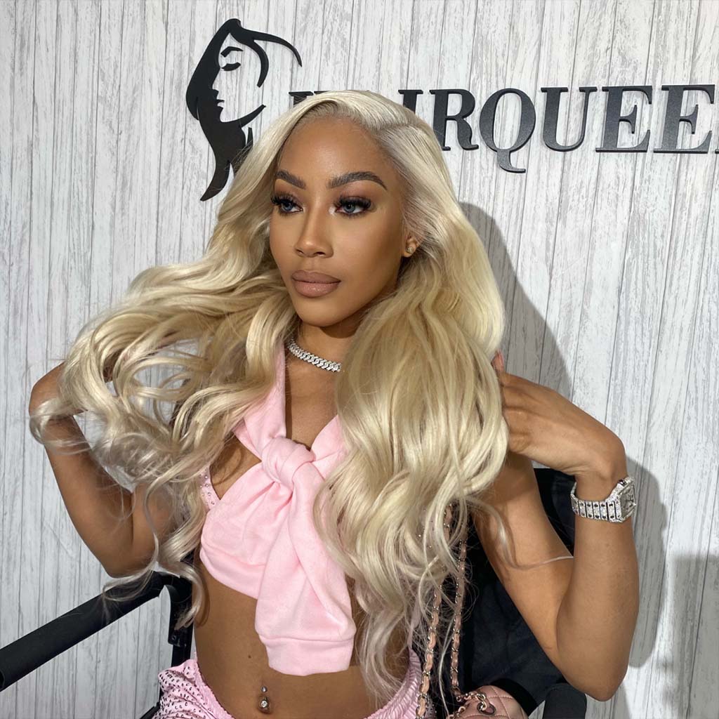 Model wearing long wavy blonde wig with pink bow top for wig install class