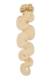 Blonde body wave clip-in extensions with small clips on narrow weft, wavy strands